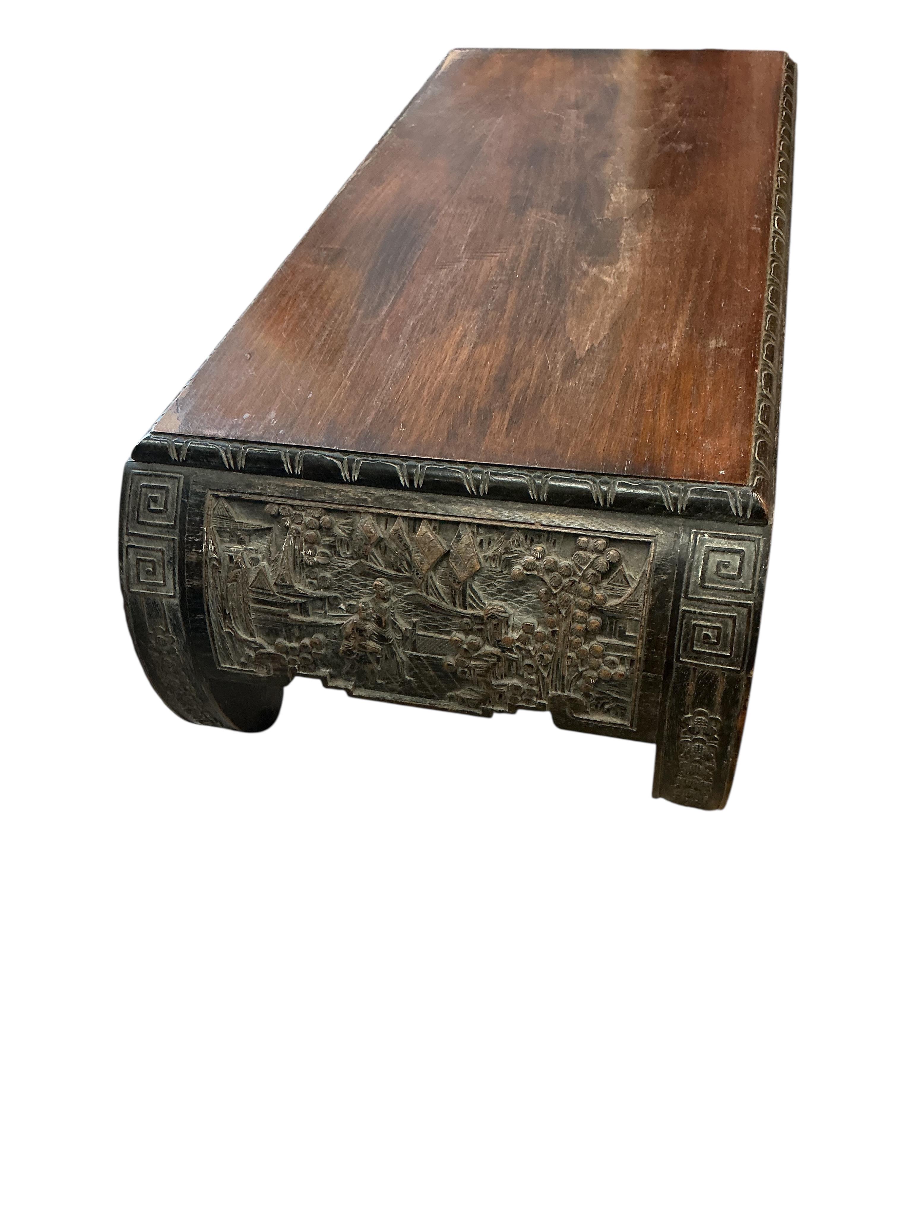 A Chinese carved low table, width 92cm, depth 40cm, height 28cm